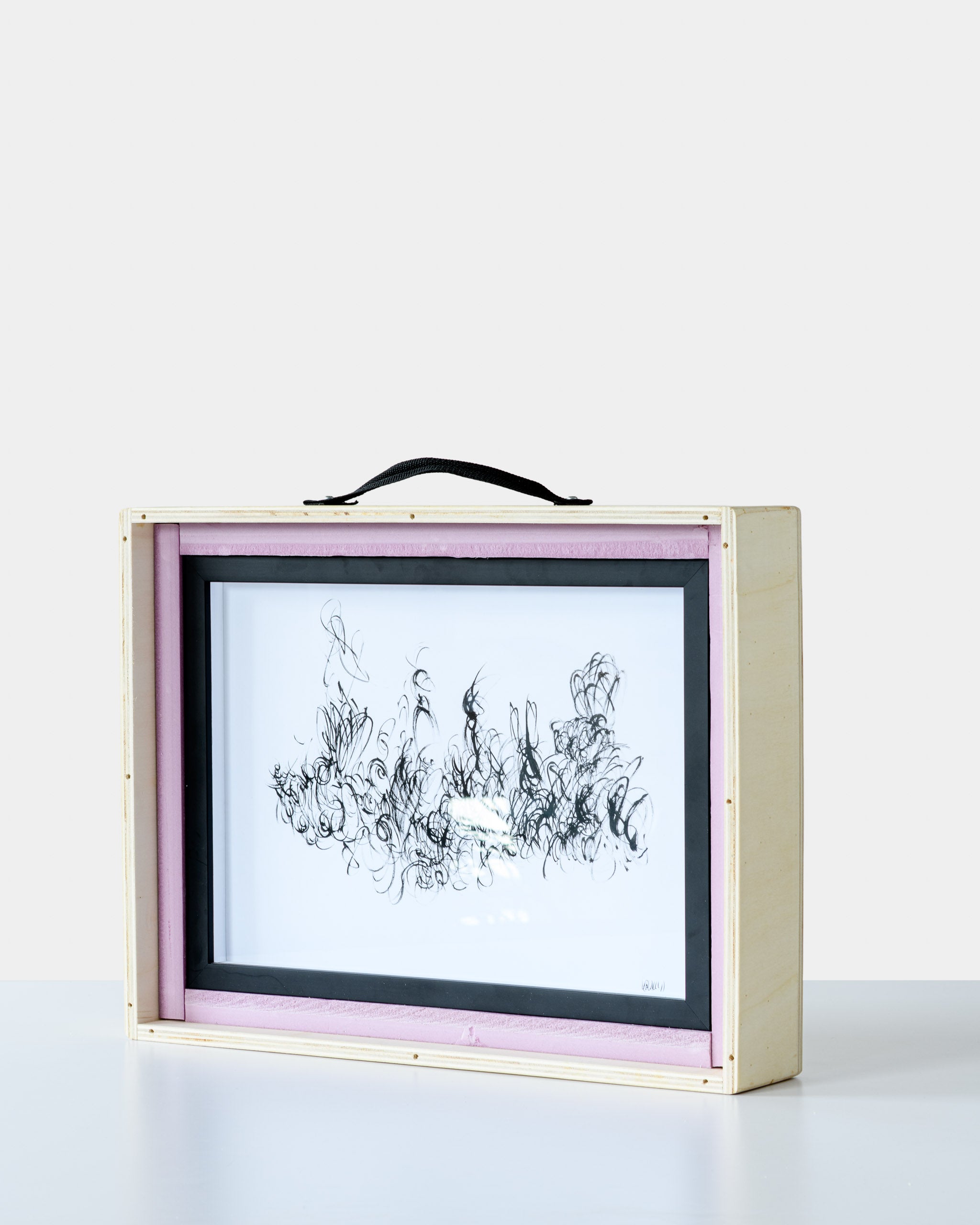 Framed artwork “Melancholy” by Ali Khanafer secured inside a custom wooden crate with pink foam edges, showcasing premium art packaging by GEMS.