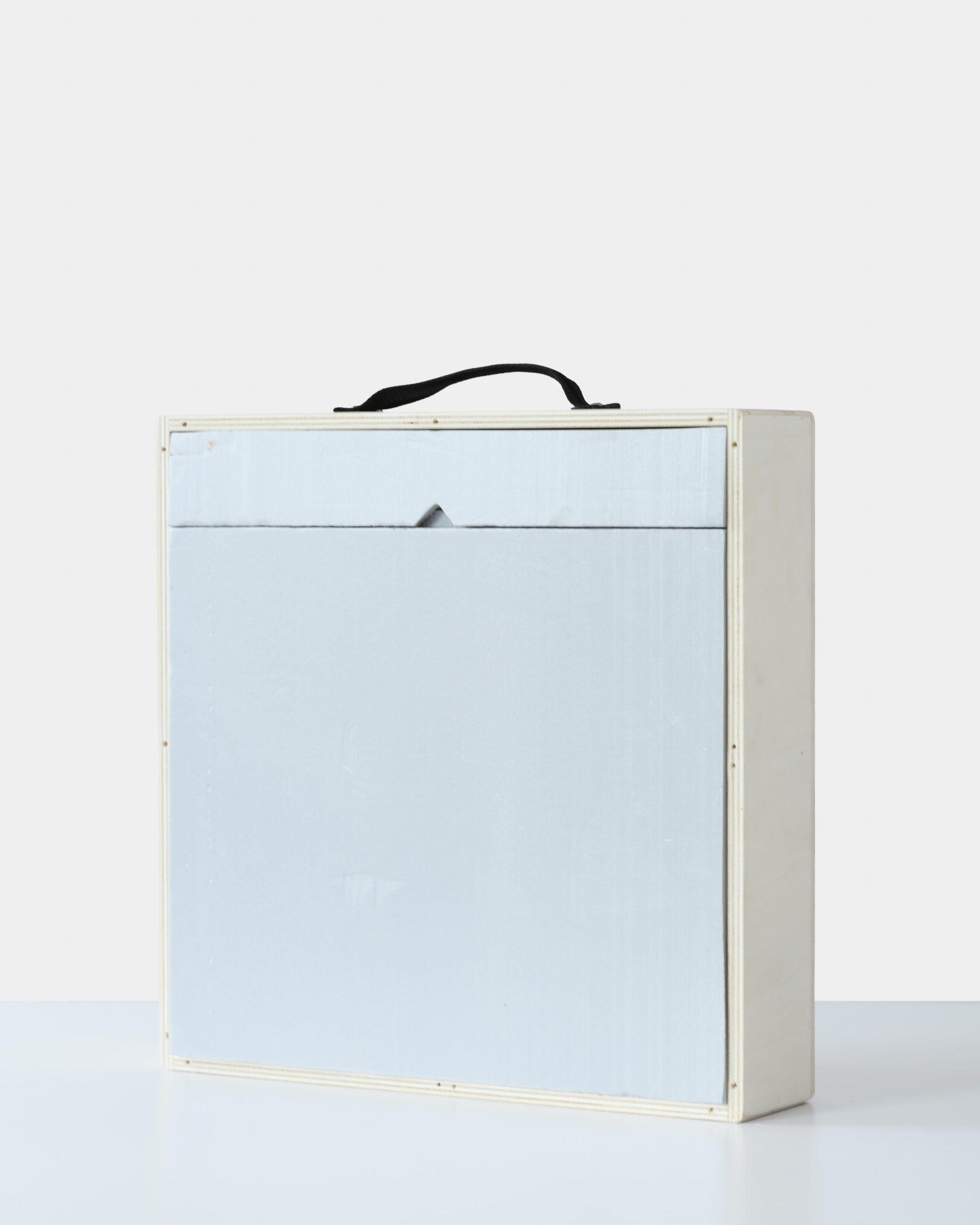 Wooden art shipping crate with a front foam panel insert and a black fabric handle, designed for safe transportation of fine art.