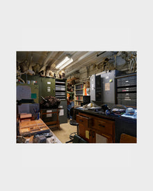 Photograph of a Storage room with shelves, cabinets, and various items on a white background