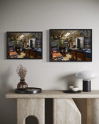 Two framed pictures on a wall above a stone console table with decorative items.